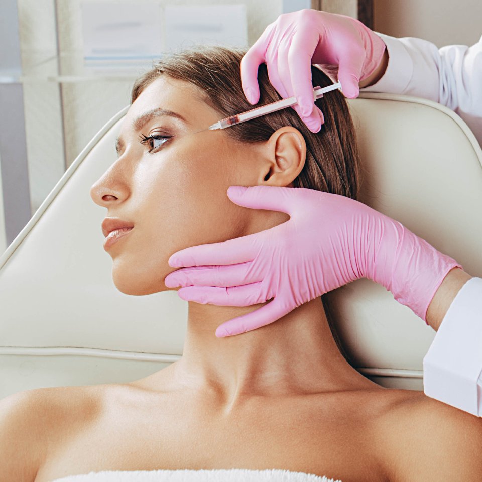 Anti aging procedure, cosmetologist making injection